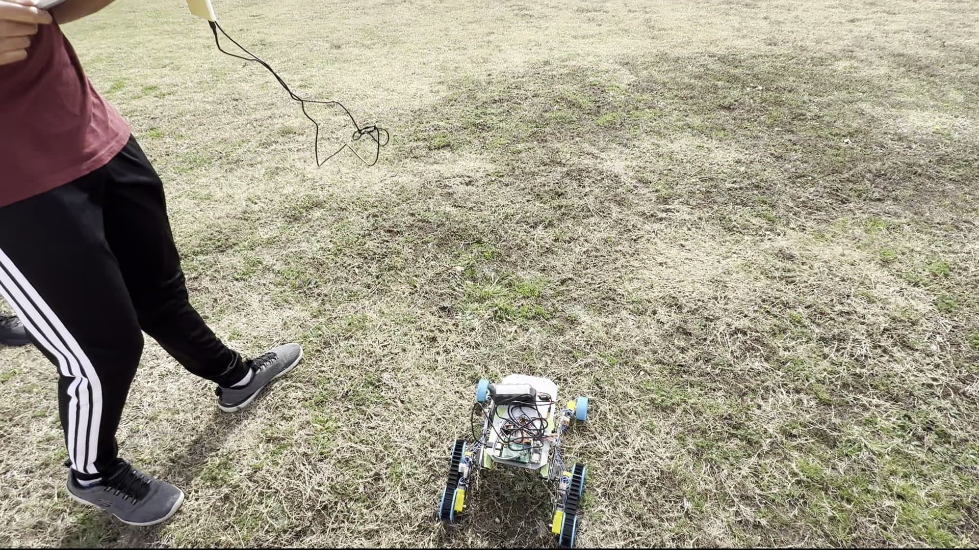 Team member walking alongside rover