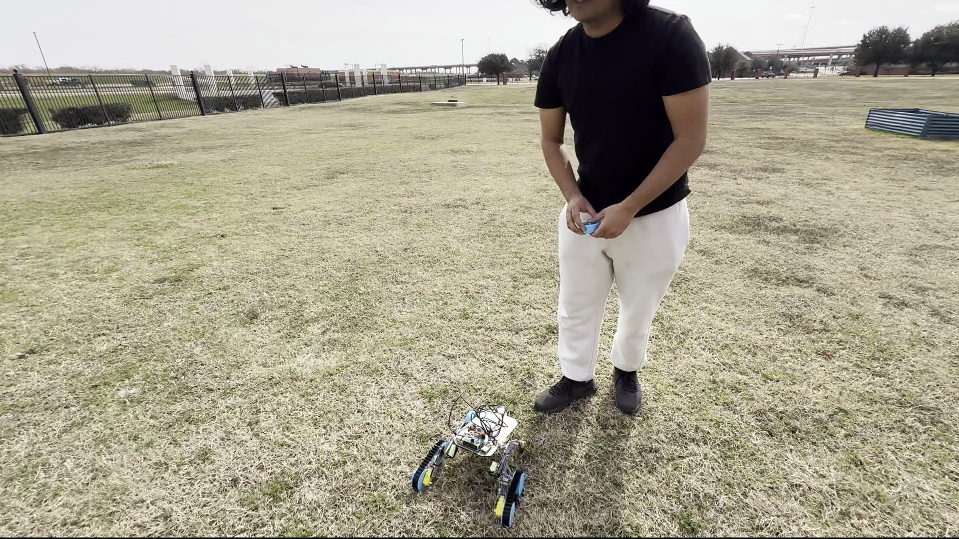 Team member with rover on grass