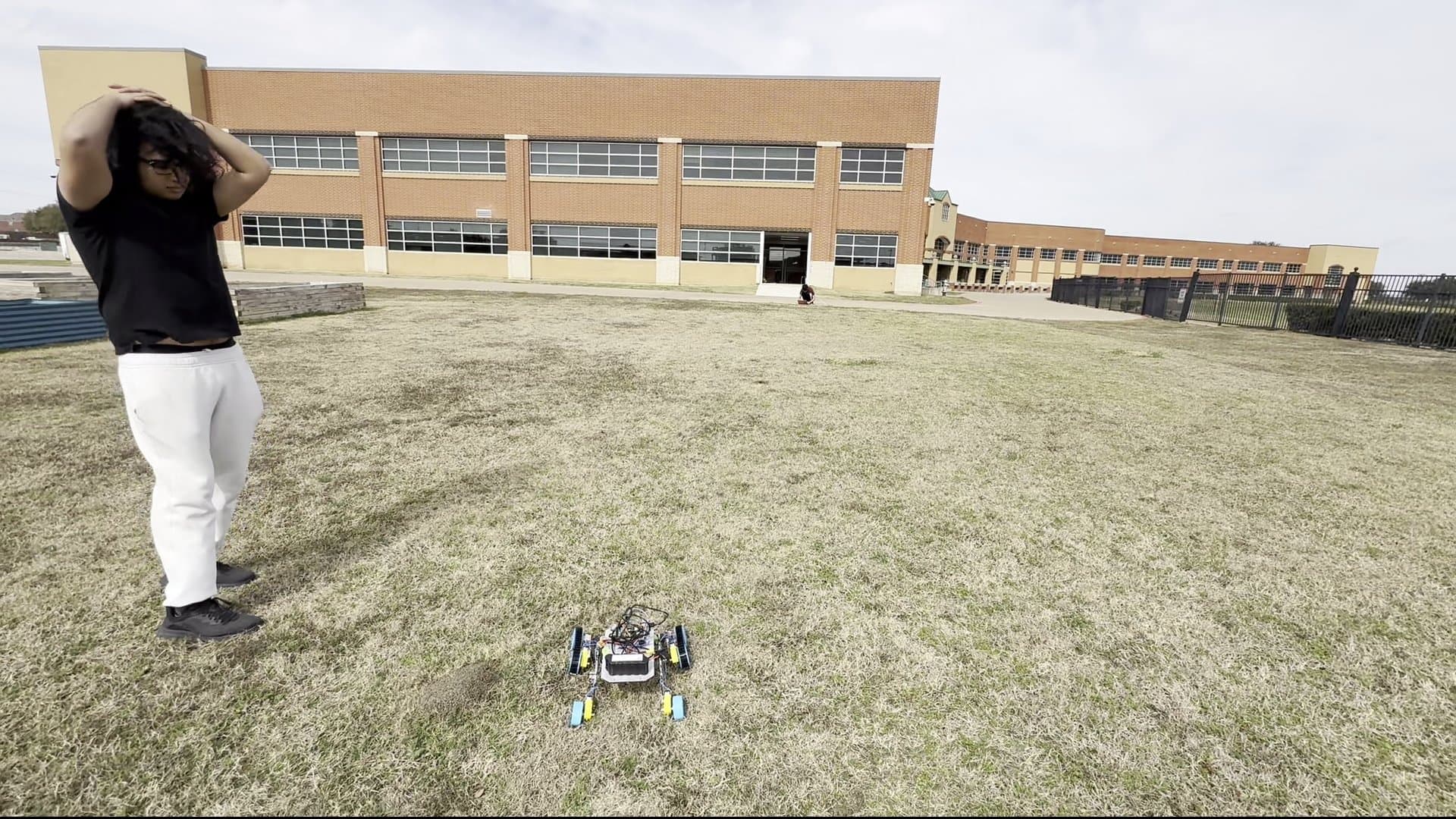 Rover on grass in front of school