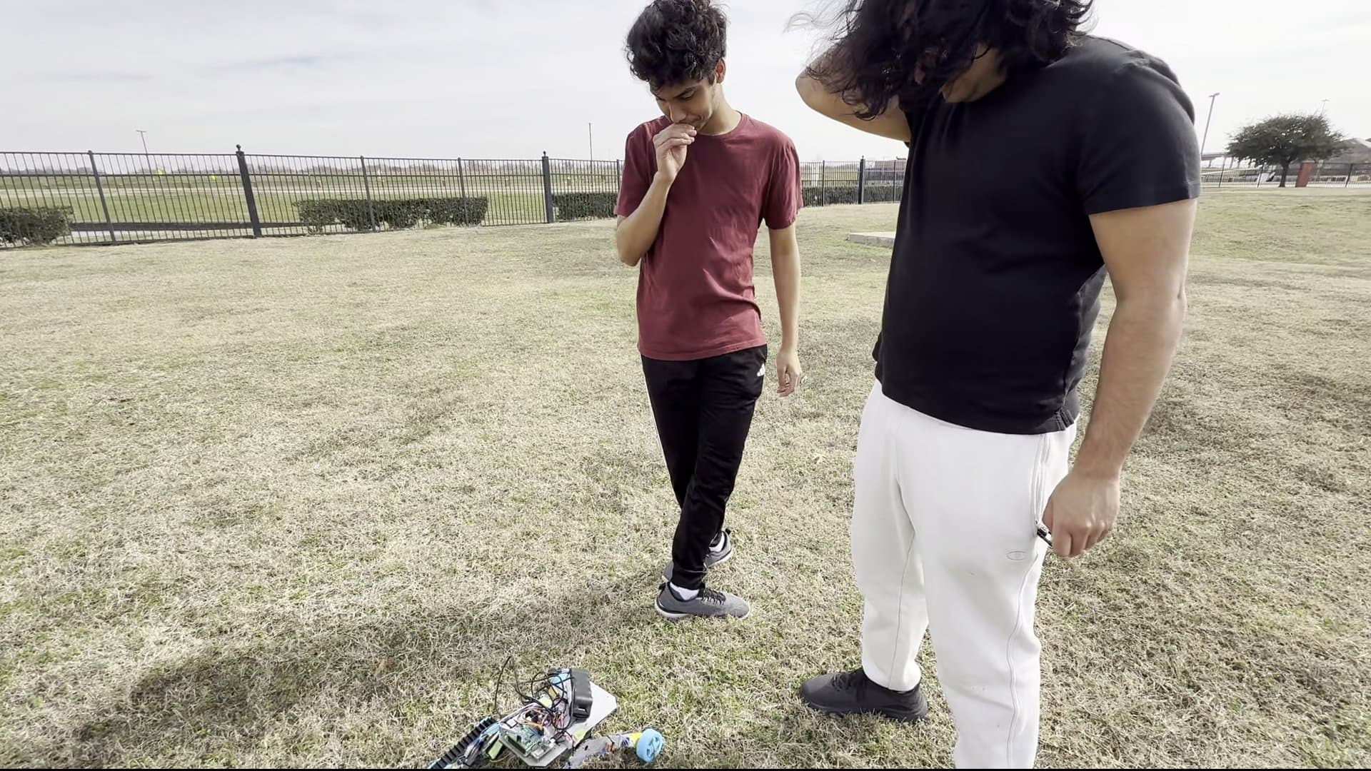 Two team members with rover outdoors